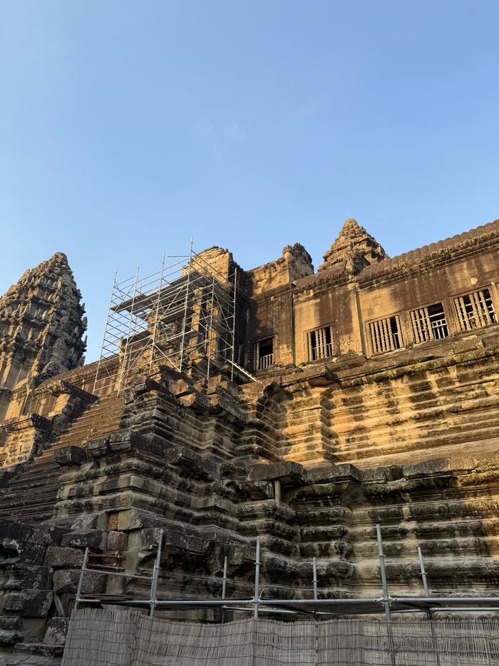 The towers of Angkor Wat, one partly under scaffolding