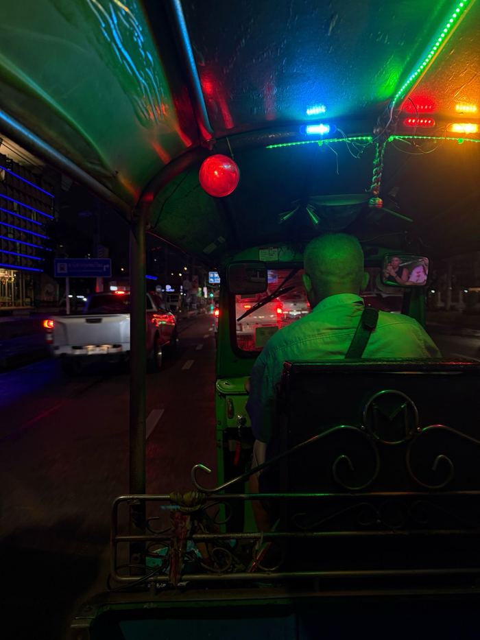 The view from the back seat of a tuk-tuk at night