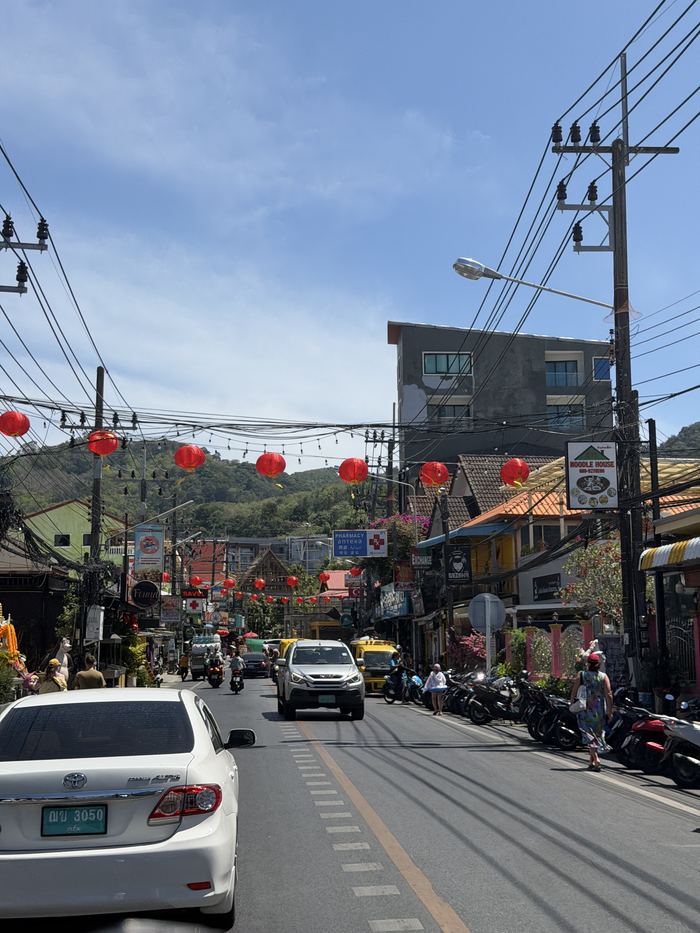 A Phuket street with red lanterns and tangled power lines