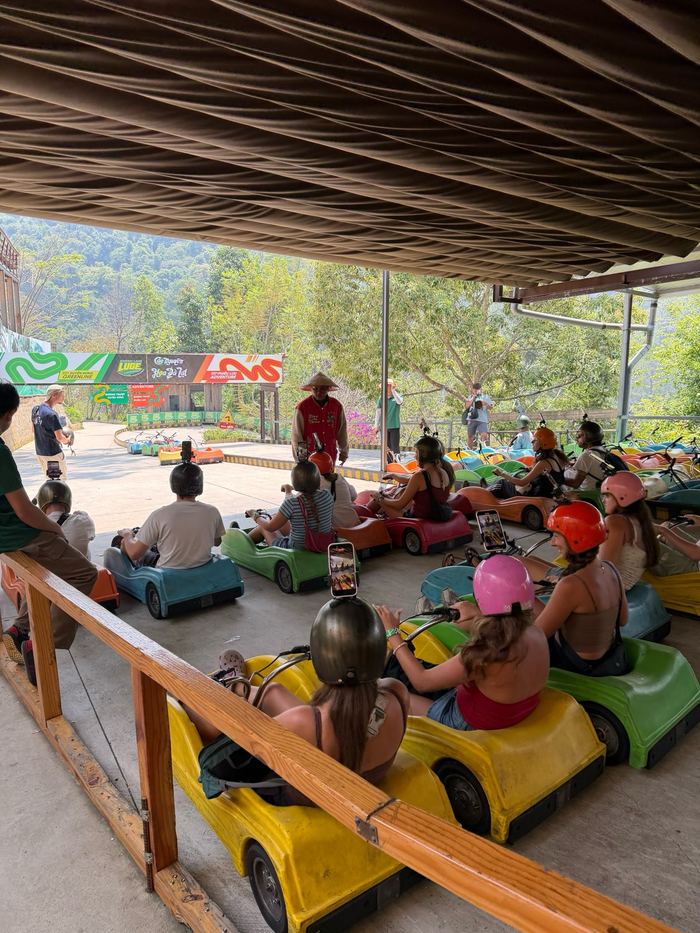 People sitting in colorful go-karts