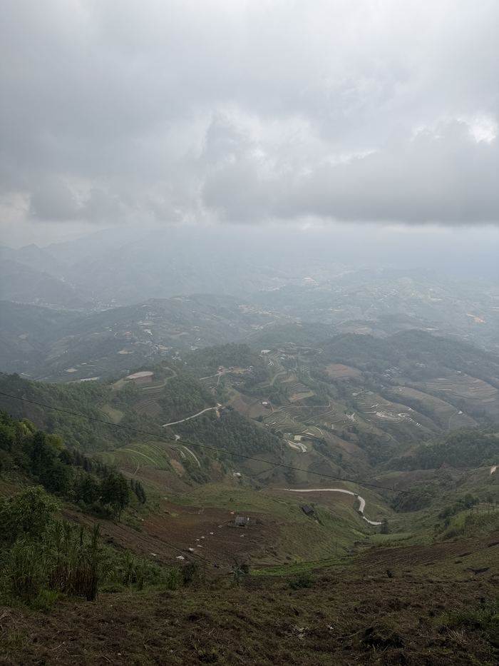 A wide valley under heavy cloud