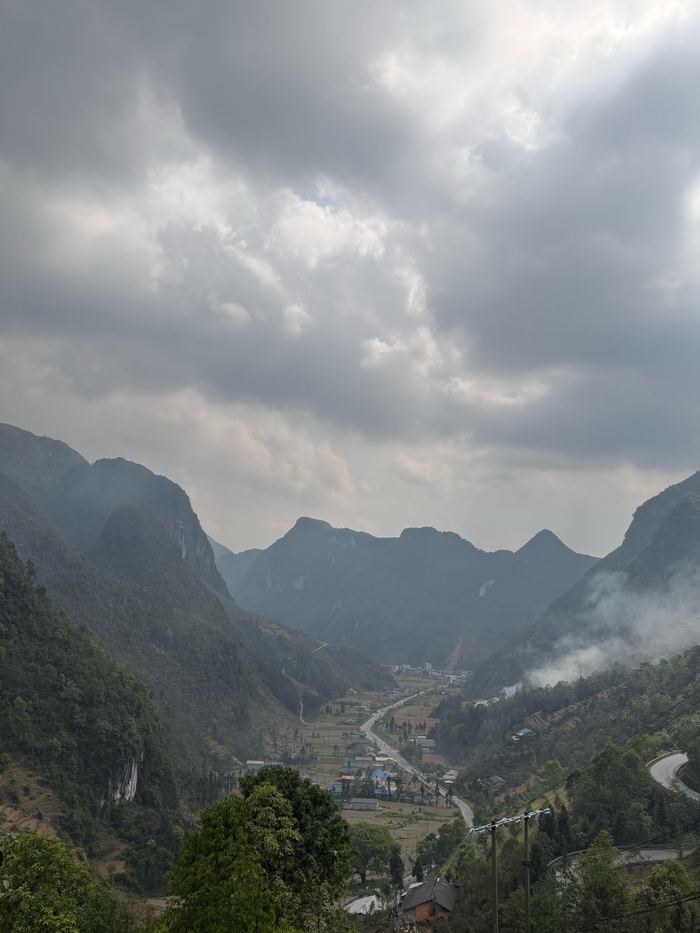 A deep valley between steep mountains under cloud