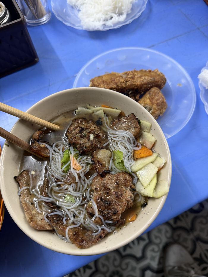 Bun cha with grilled pork, noodles, and spring rolls