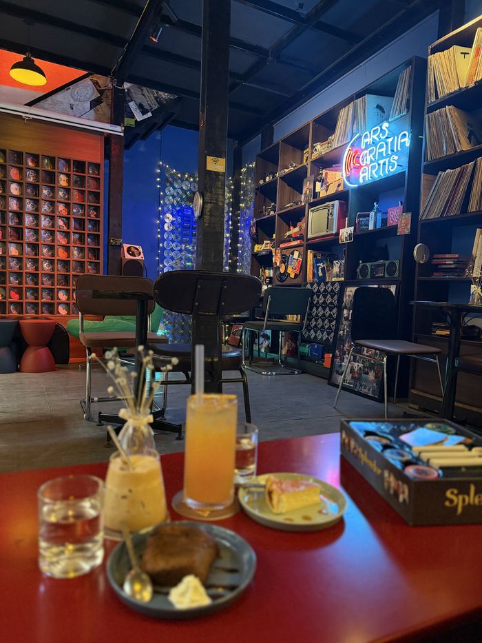 Drinks and a board game in a cafe lined with records