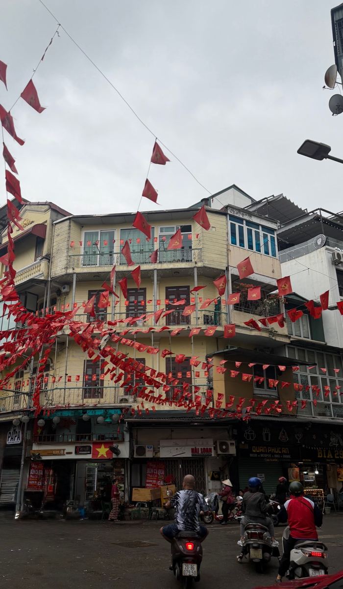 A Hanoi street strung with red Vietnamese flags