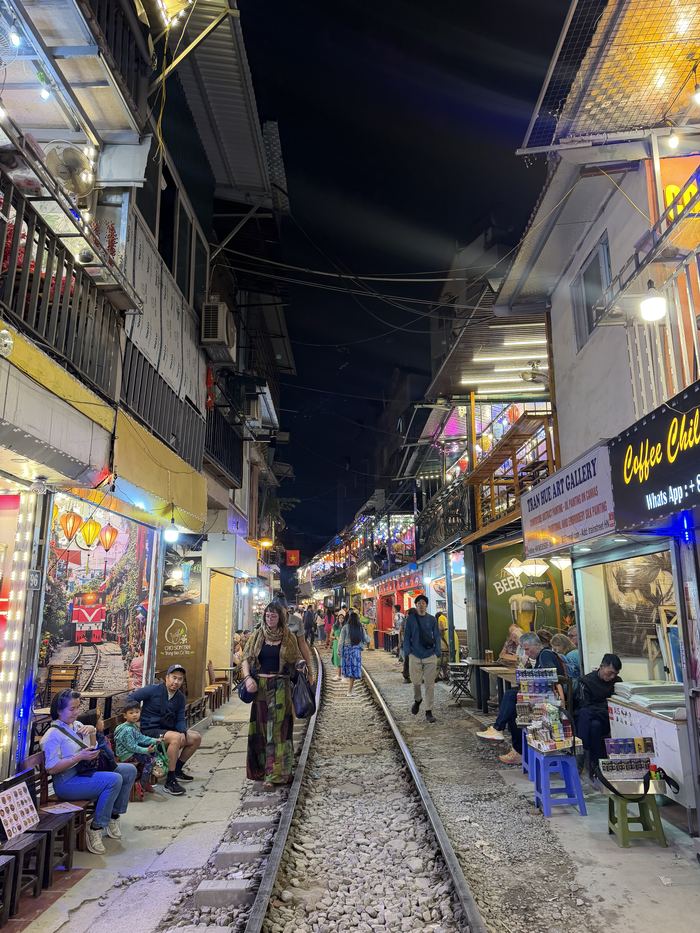 Cafes lining the narrow tracks of Hanoi's Train Street at night