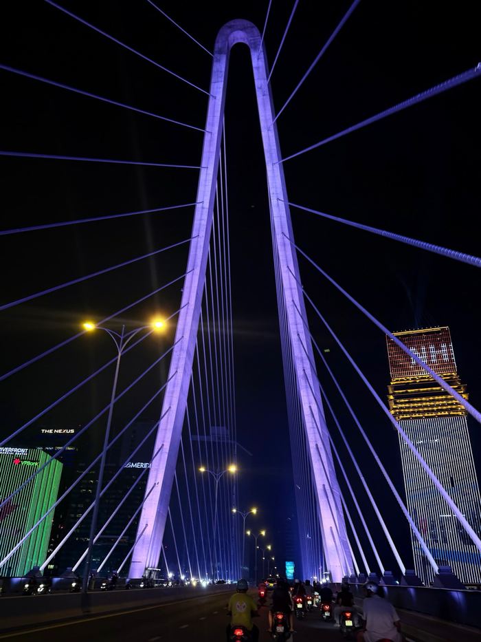 A cable-stayed bridge lit purple at night