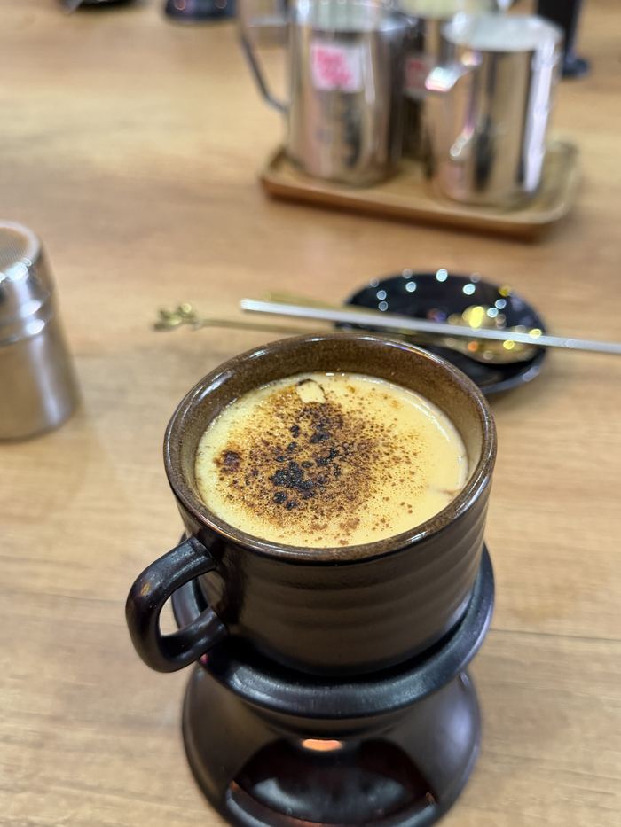 An egg coffee in a cup on a warming stand