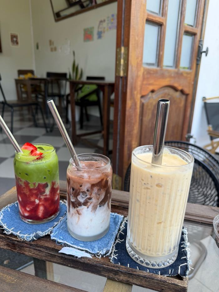 Three iced drinks on a cafe table