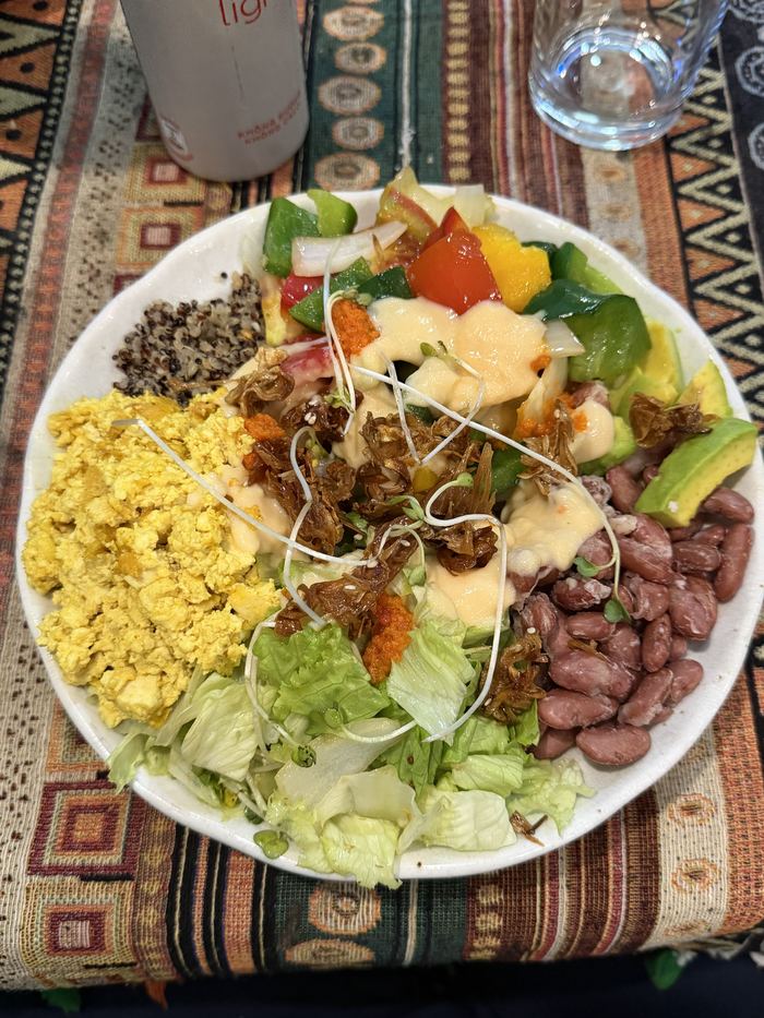 A colorful salad with beans, egg, and vegetables