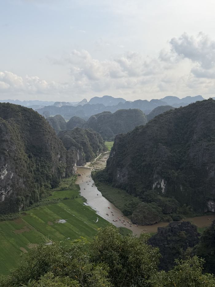 A river winding through rice fields between karst mountains